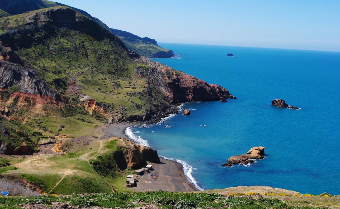 Фото Plage de Zouanif с песок с камнями поверхностью