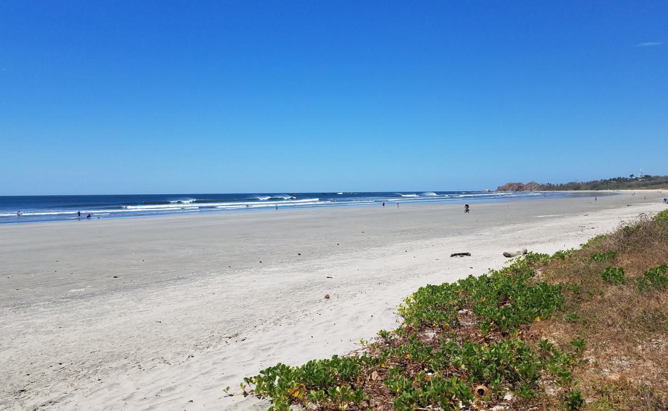 Фото Playa Guiones с песок с камнями поверхностью