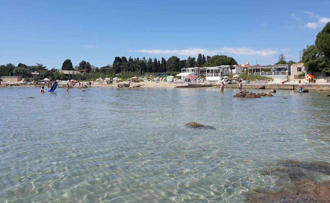 Фото Zambratija beach с светлый песок поверхностью