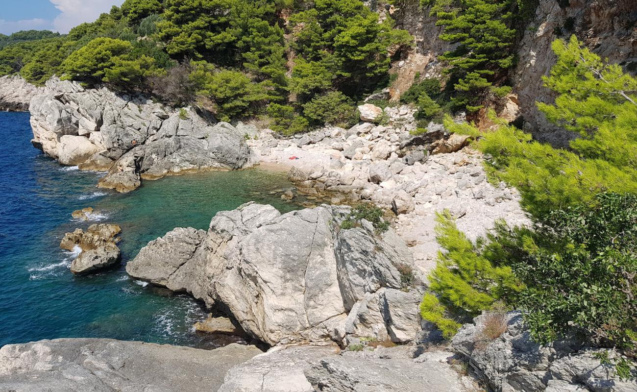 Фото Gof beach с песок с камнями поверхностью