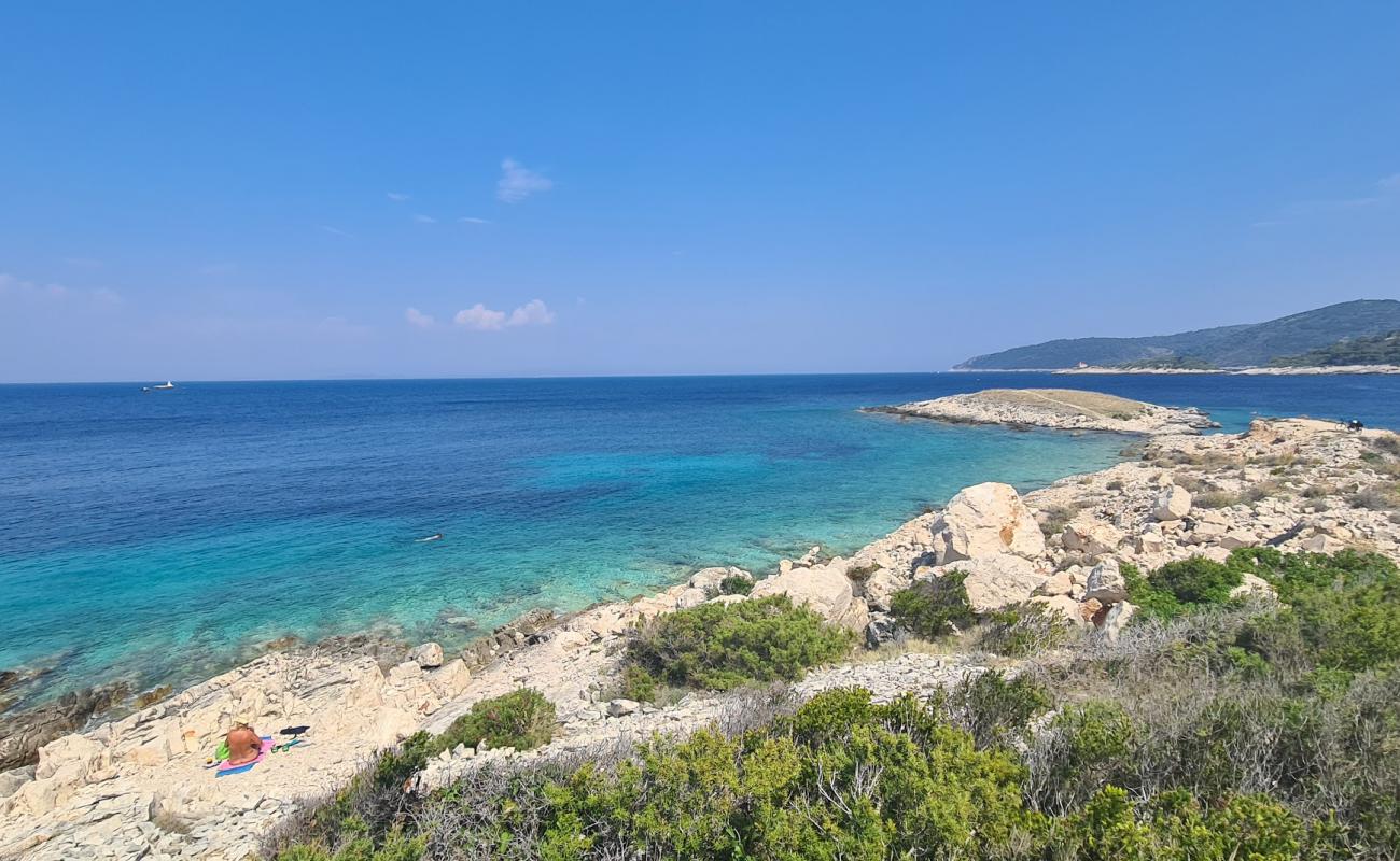 Фото Komarca beach с камни поверхностью