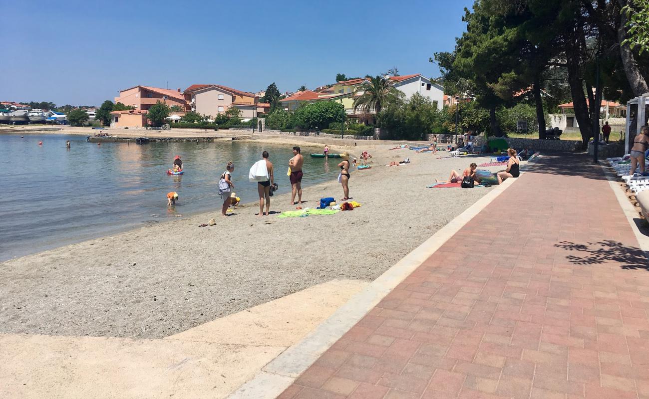 Фото Beach Banjol с белая чистая галька поверхностью