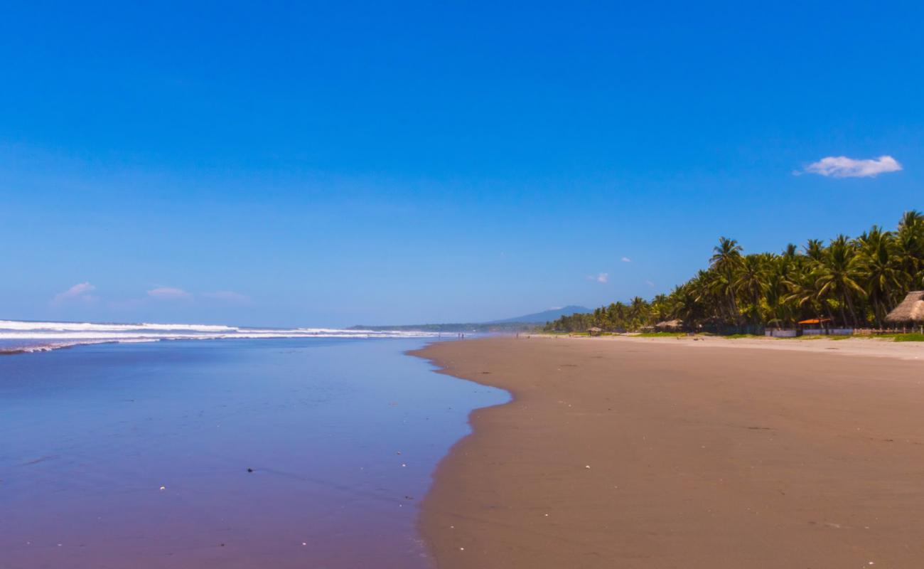 Фото Los Caracoles beach с серый песок поверхностью