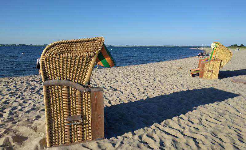 Фото Strand Langballig с светлый песок поверхностью