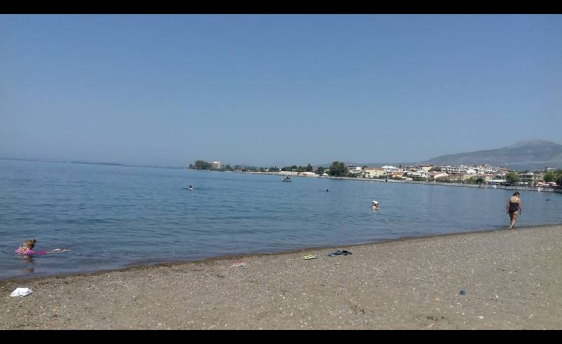 Фото Amarynthos 2 beach с серый песок поверхностью