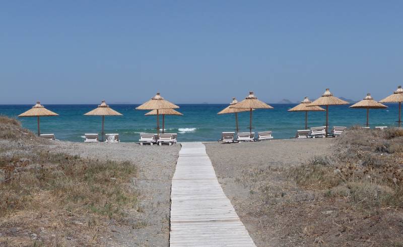 Фото Blue lagoon beach с серый песок поверхностью