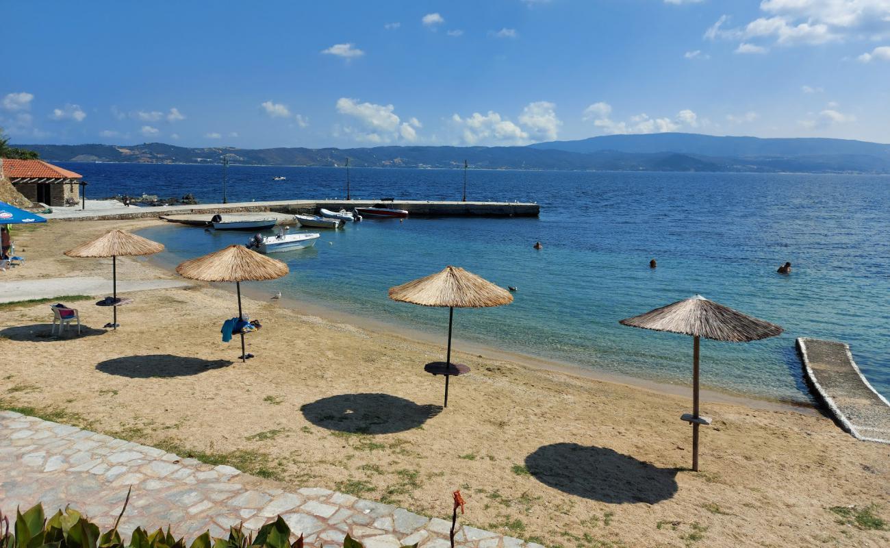 Фото Tzanis beach с светлый песок поверхностью