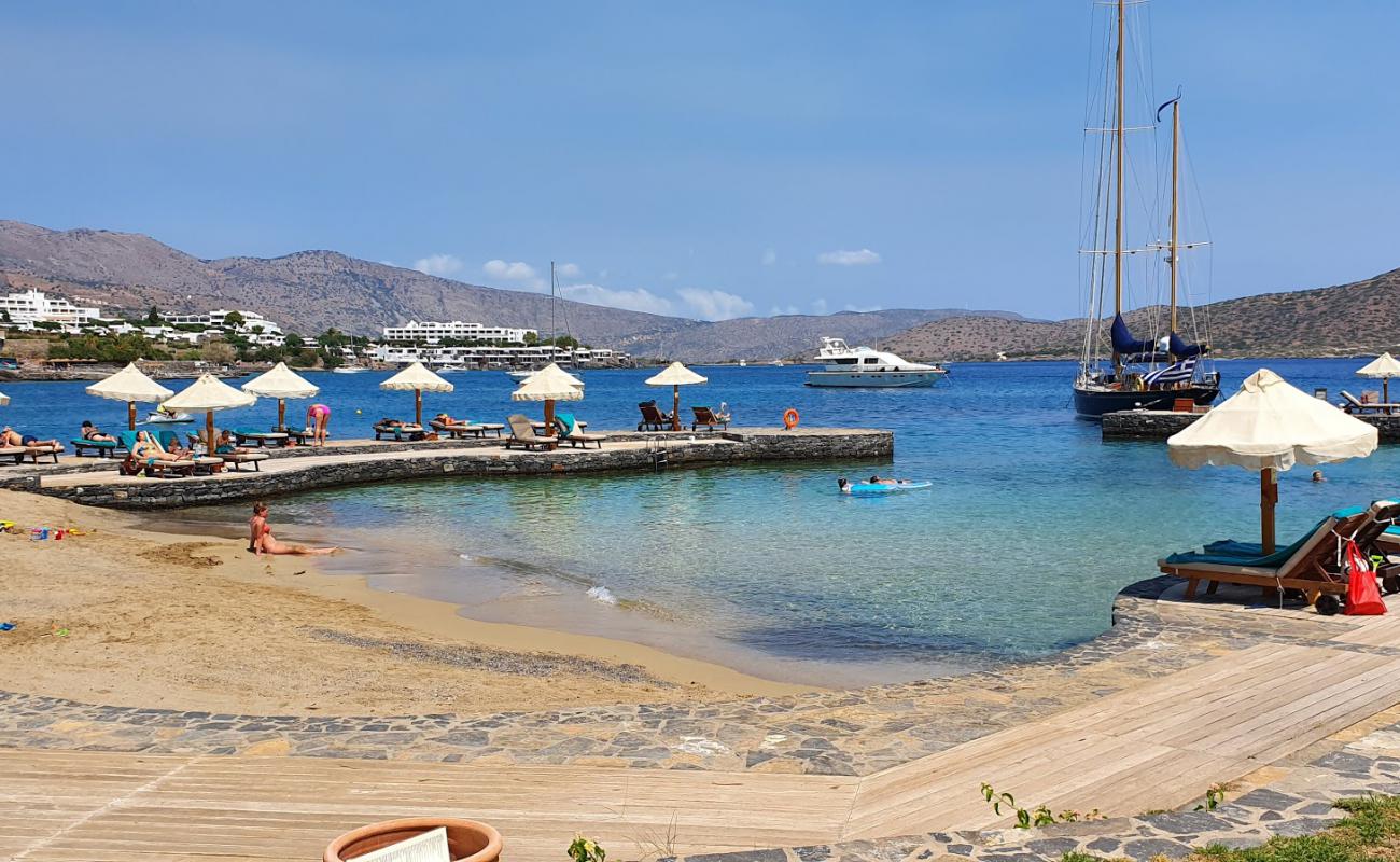 Фото Elounda Beach III с темный чистый песок поверхностью