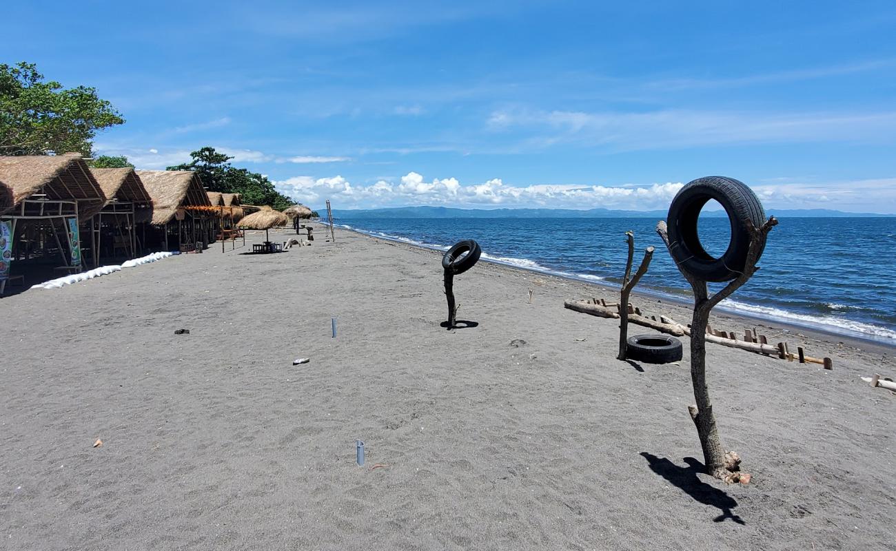 Фото Batas Senja Beach с темный песок поверхностью