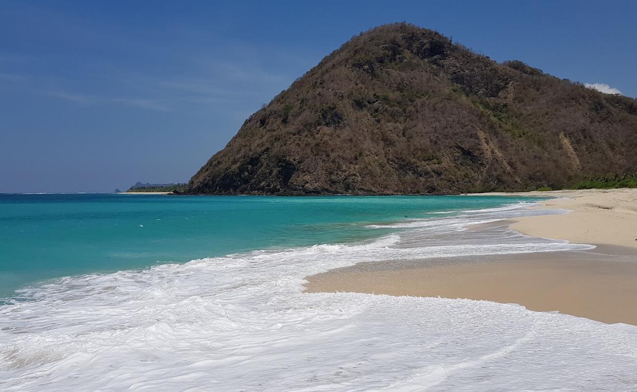 Фото Tomang-Omang Beach с белый чистый песок поверхностью