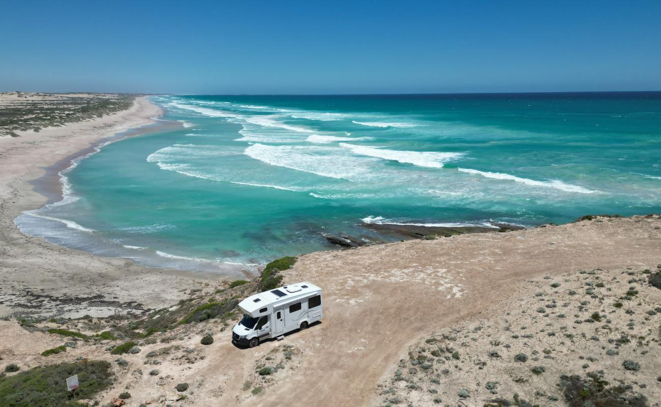 Фото Talia Beach с светлый песок поверхностью