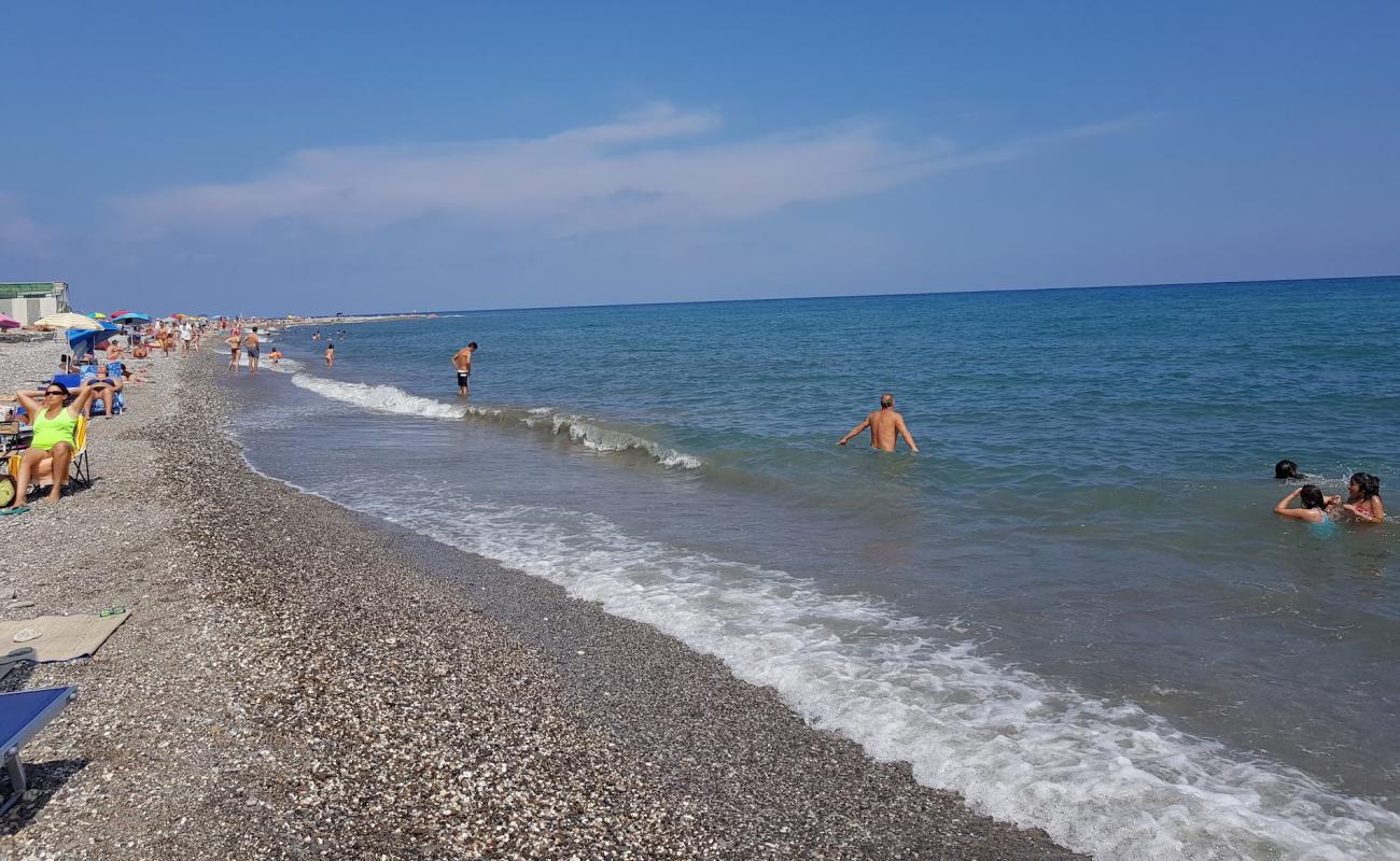 Фото Capo Lena beach с песок с галькой поверхностью