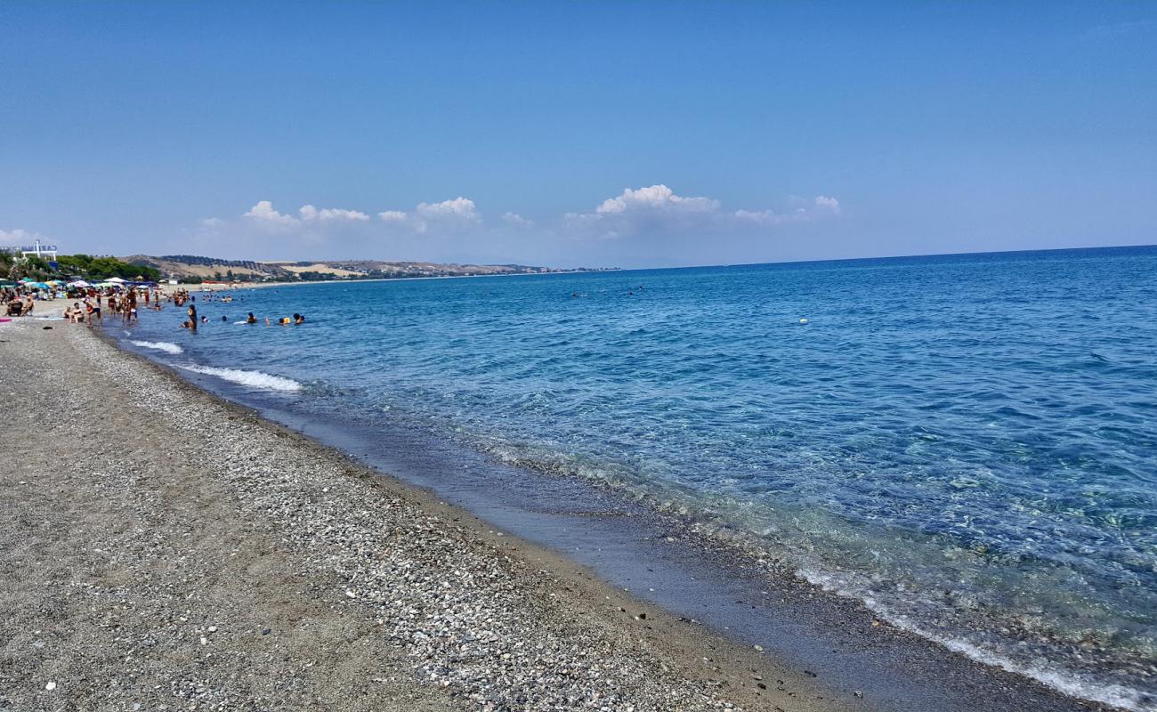 Фото Antico beach с песок с галькой поверхностью