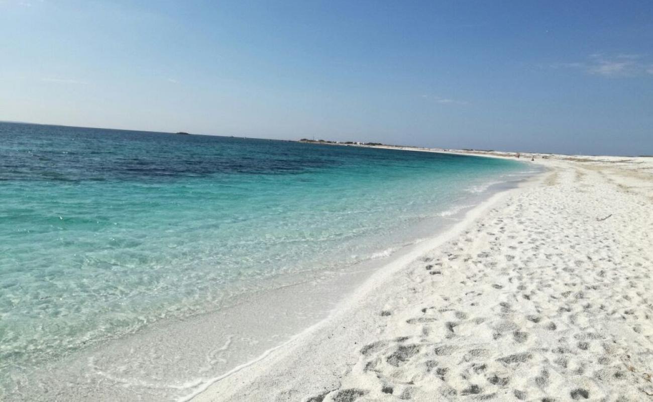 Фото Spiaggia di Portu S'Uedda с светлый песок поверхностью