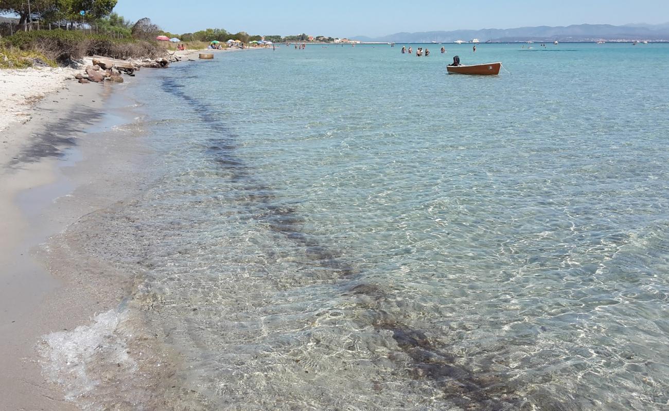 Фото Giunco beach с светлый песок поверхностью