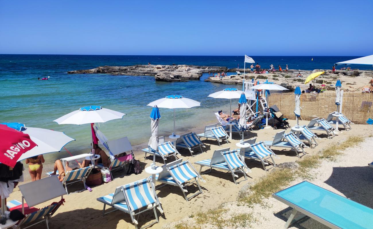 Фото Lido Cala Pescatore с светлый песок поверхностью