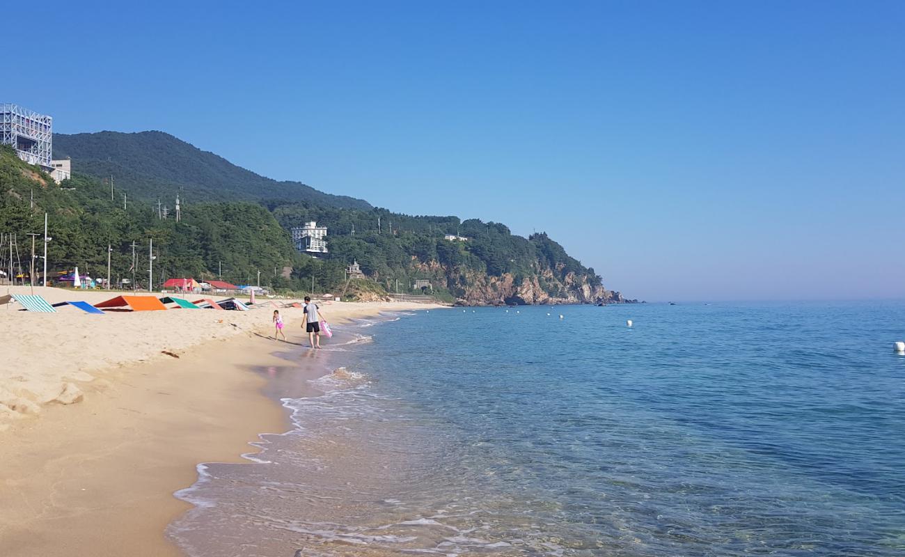 Фото Deungmyeong Beach с светлый песок поверхностью