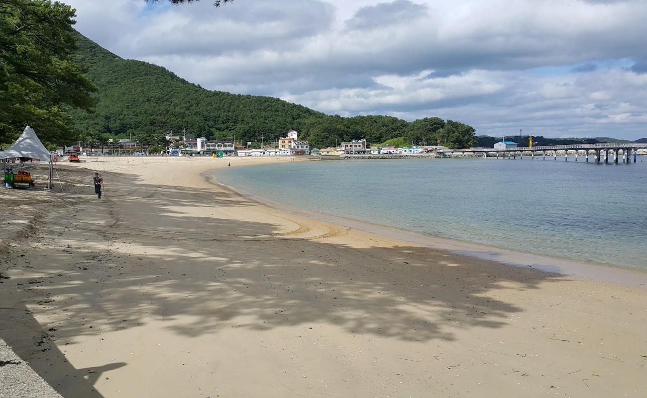 Фото Myeongsa Beach с светлый песок поверхностью