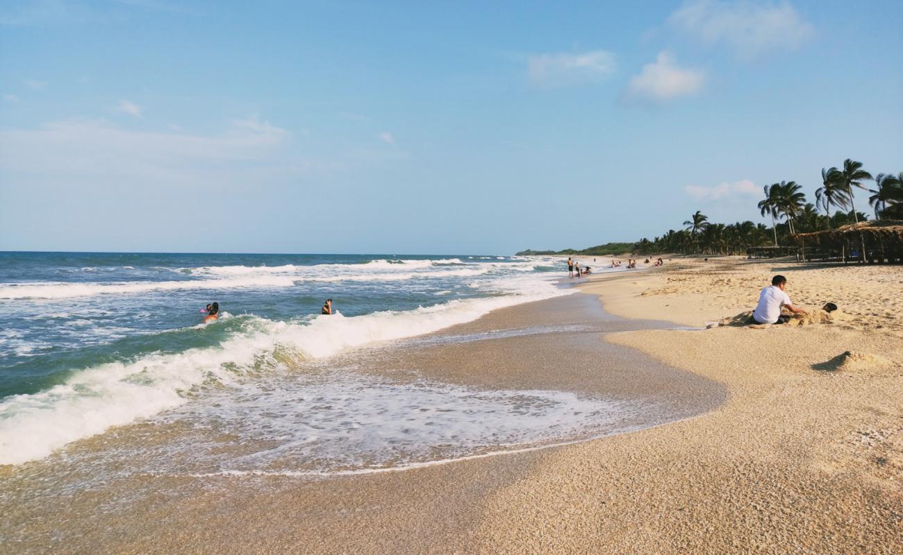 Фото Playa Chaparrales с светлый песок поверхностью