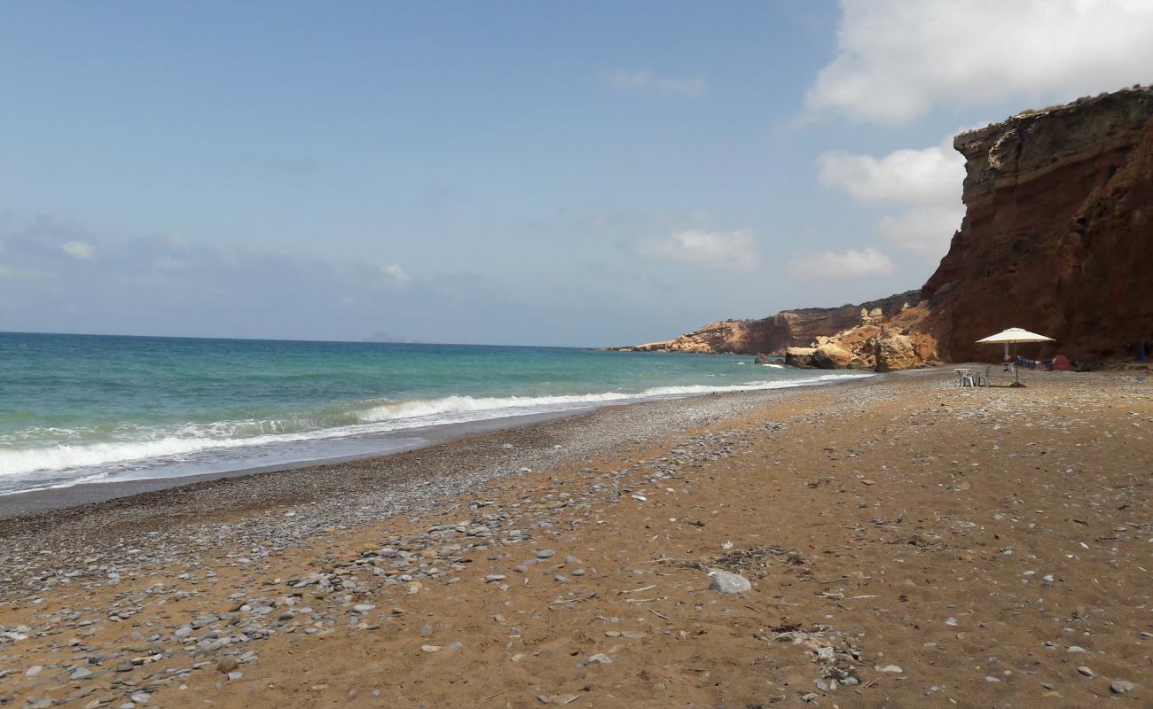 Фото Boufadisse beach с темная галька поверхностью