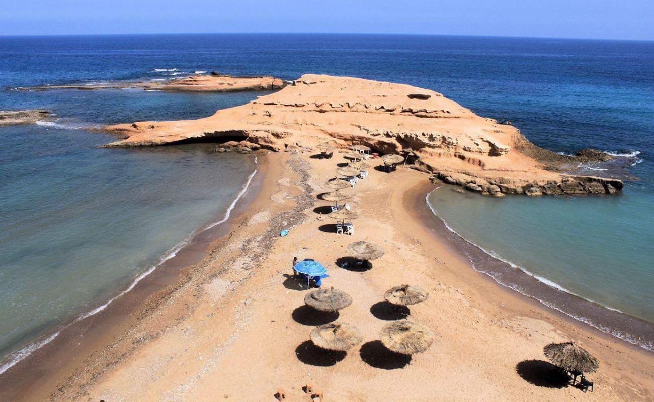 Фото Plage Sidi El Bachir с темный песок поверхностью