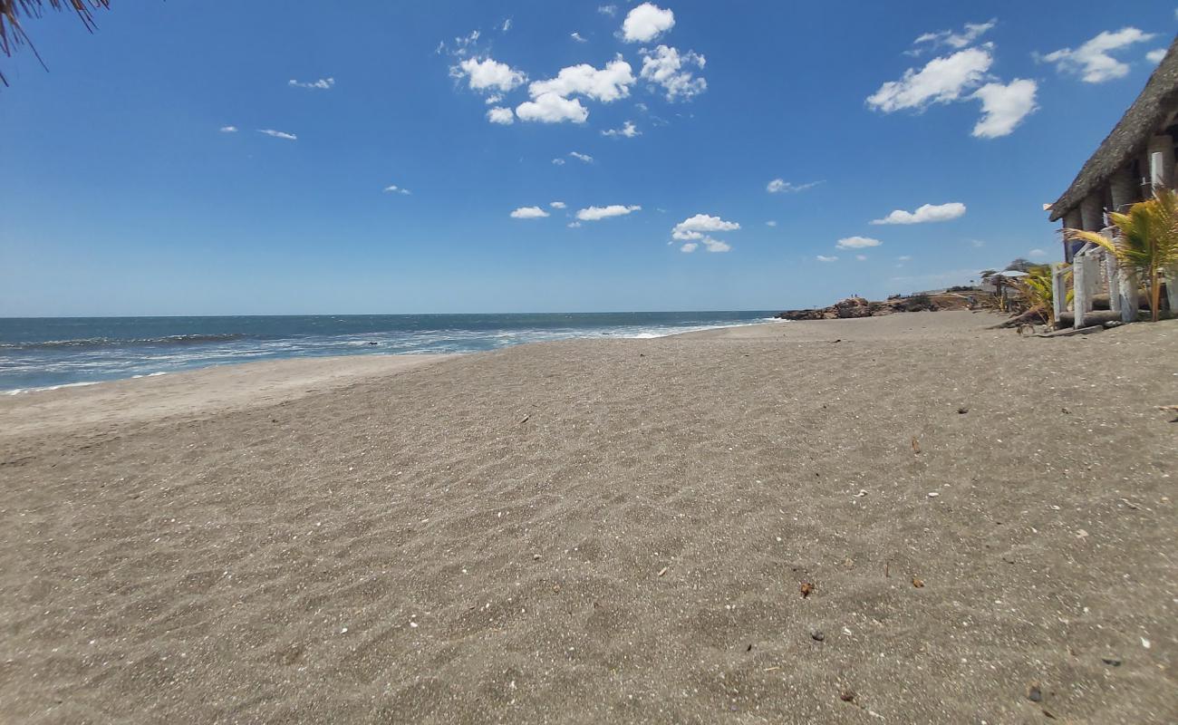 Фото Las Penitas beach с серый песок поверхностью