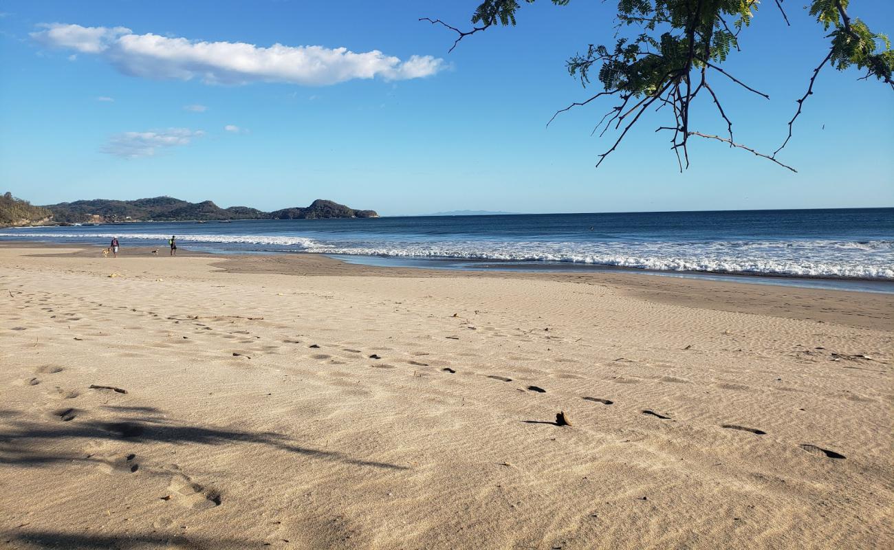 Фото Playa Colorado с золотистый песок поверхностью