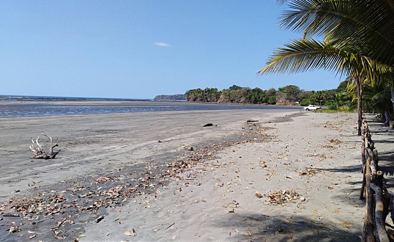 Фото Playa Arrimadero с песок с камнями поверхностью