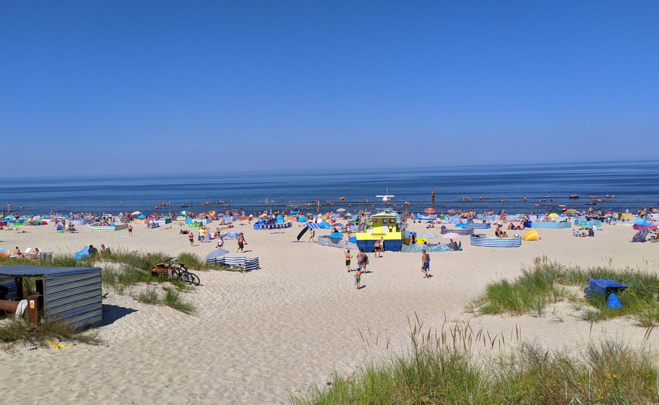 Фото Beach at the Fishing Port с светлый песок поверхностью