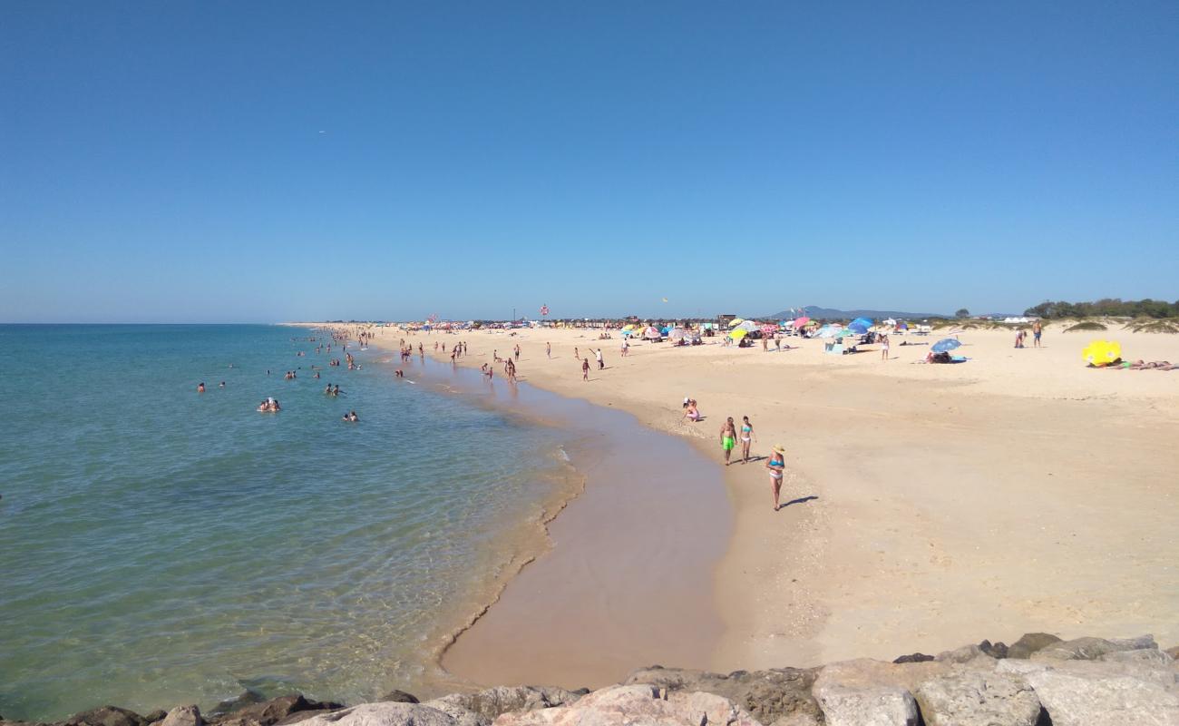 Фото Praia da Ilha de Tavira с золотистый песок поверхностью