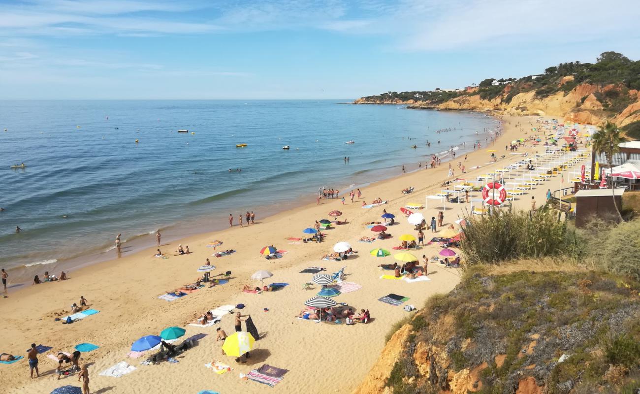 Фото Praia Maria Luisa с темный чистый песок поверхностью