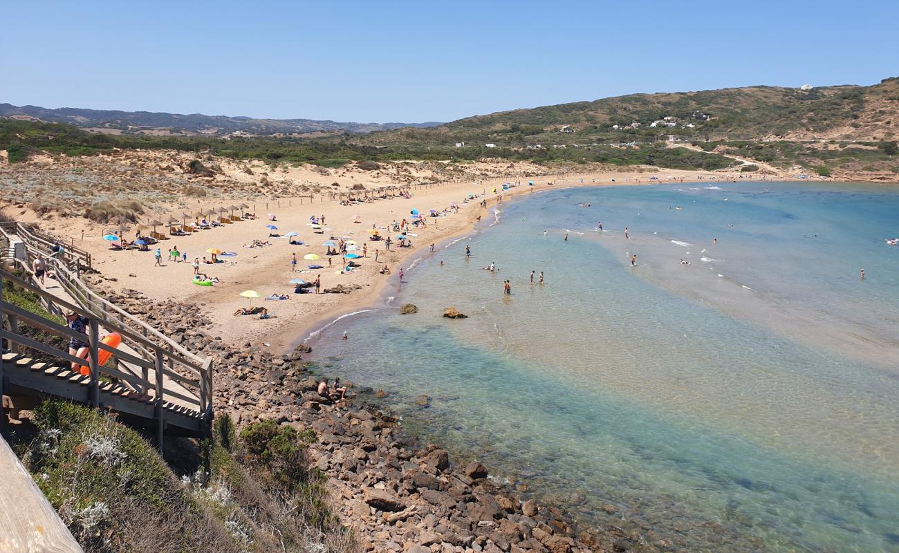 Фото Playa de Fornells с темный песок поверхностью