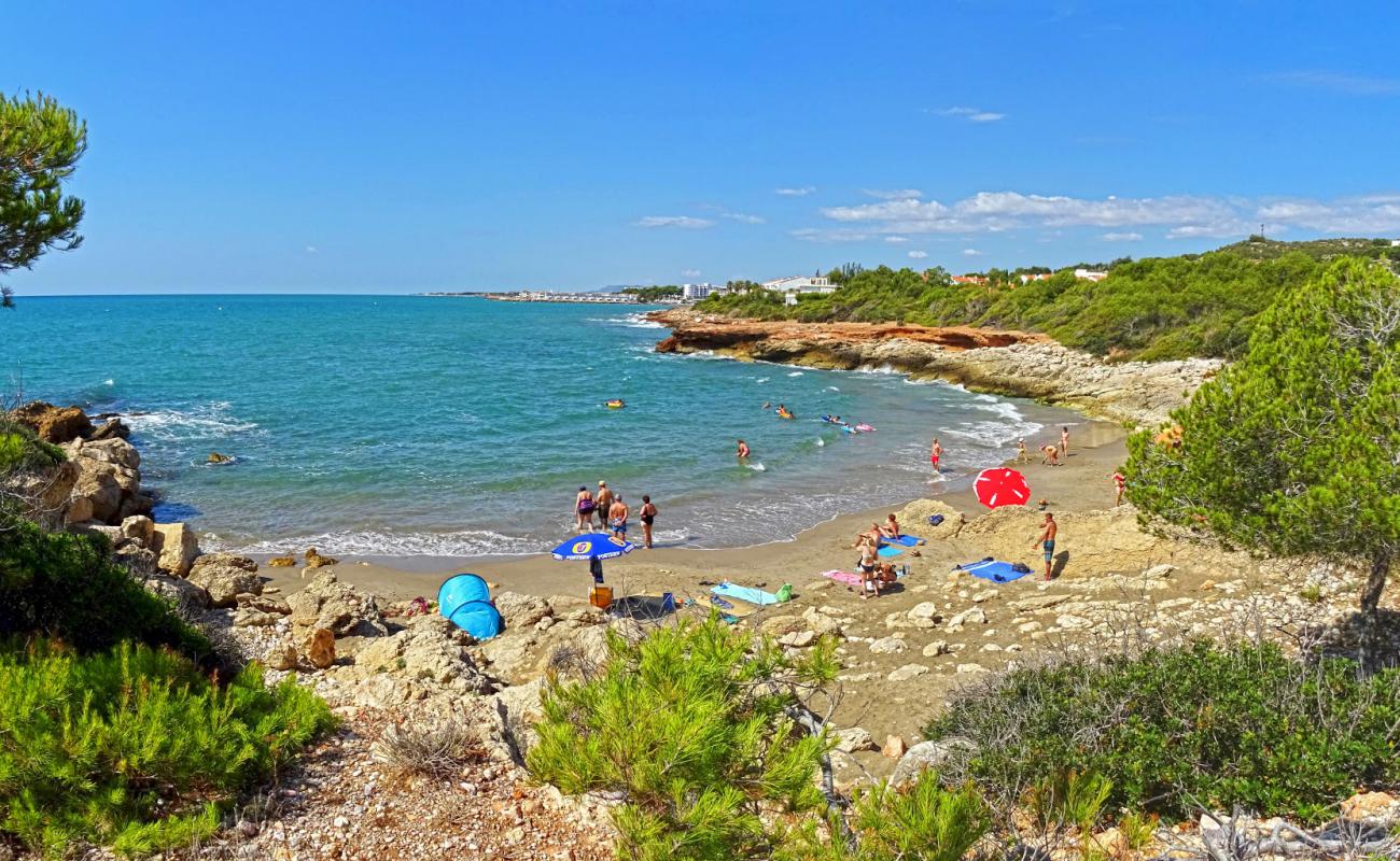 Фото Cala Blanca с темный песок поверхностью