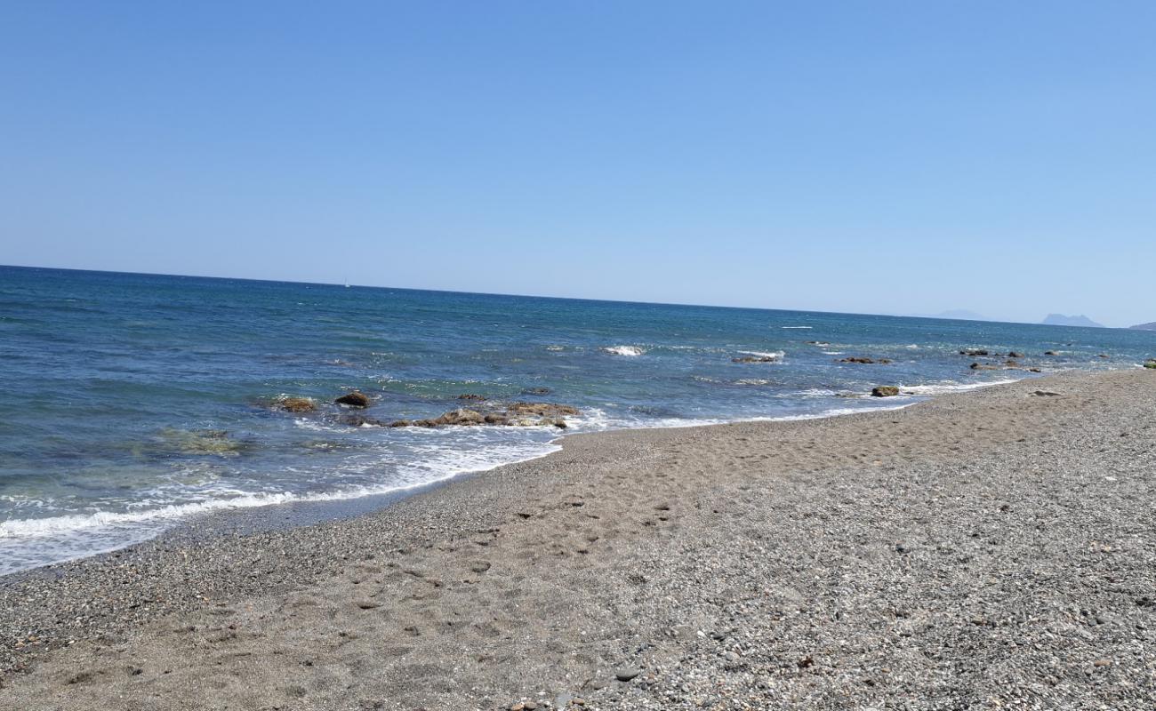 Фото Playa la Gaspara beach с серый песок поверхностью