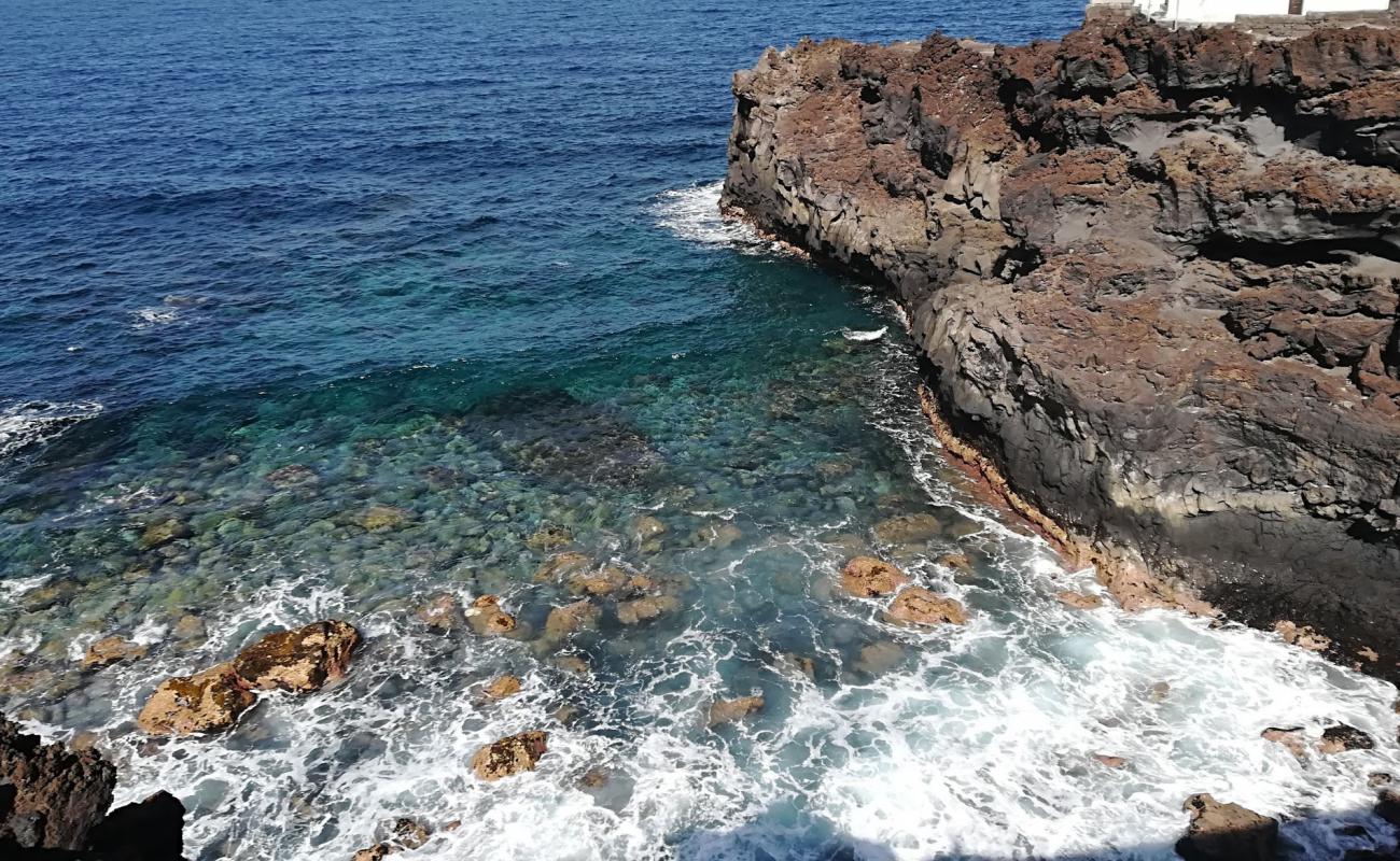 Фото Playa de los Palos с камни поверхностью