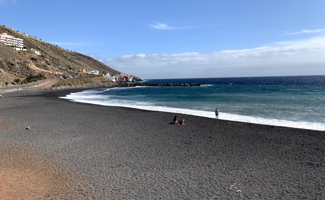 Фото Playa de la Nea с серый песок поверхностью