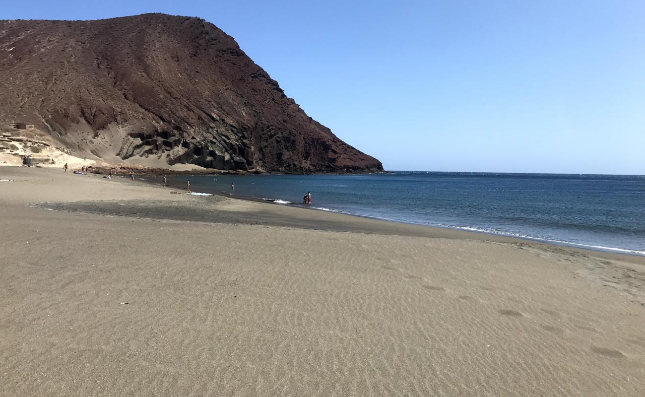 Фото Playa de la Tejita с темный песок поверхностью