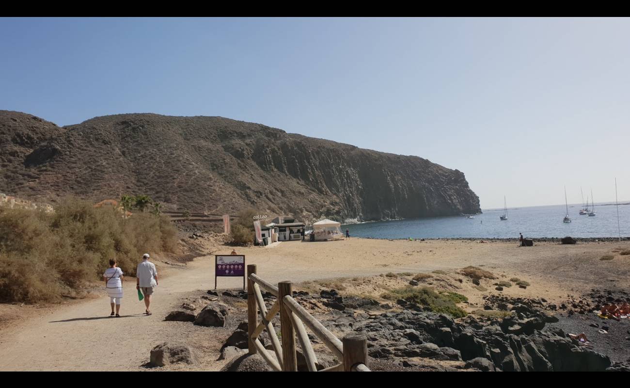 Фото Playa De Los Hippies с песок с камнями поверхностью