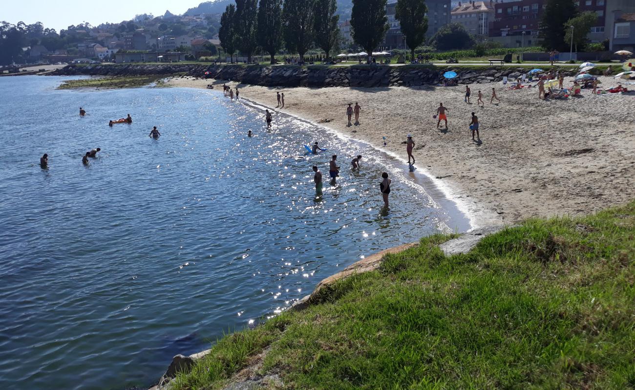 Фото Praia da Tella с белый песок поверхностью