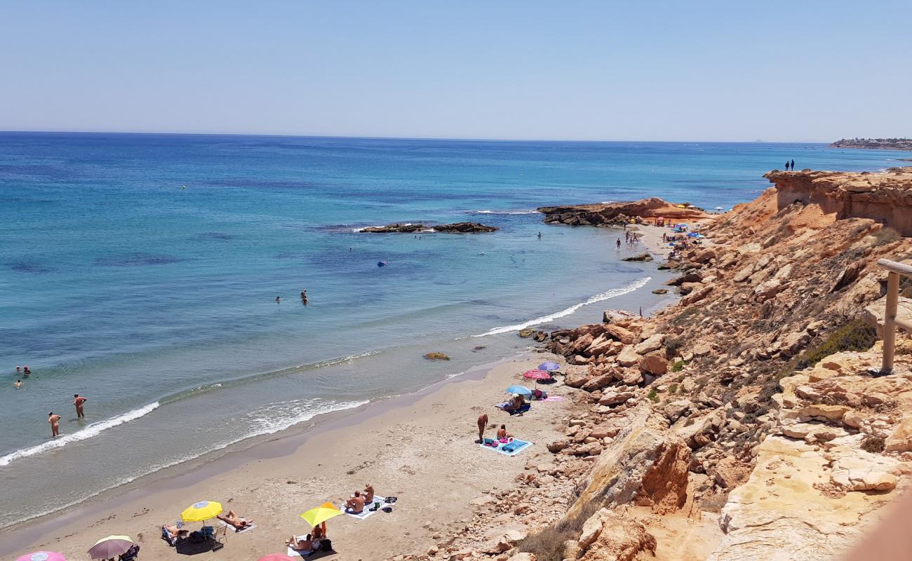 Фото Cala La Mosca с светлый песок поверхностью