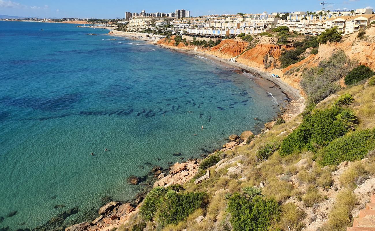 Фото Cala Aguamarina с серый песок поверхностью