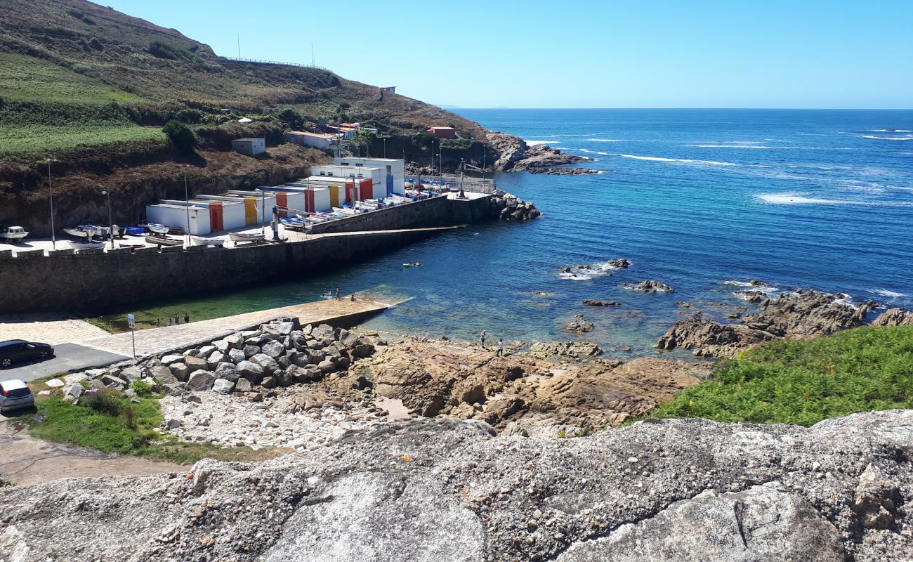 Фото Cala do Portino с светлый песок поверхностью