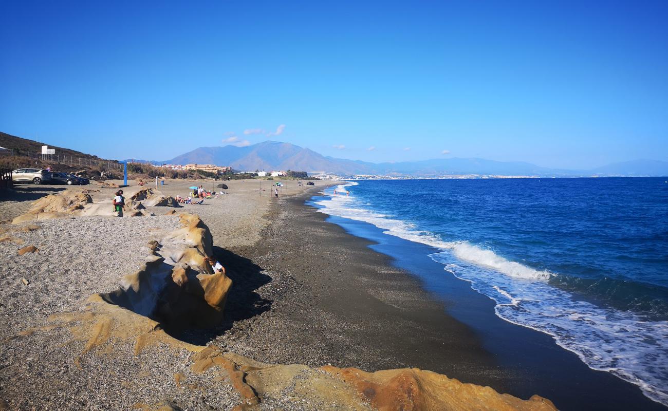 Фото Playa Aldea с серый песок поверхностью