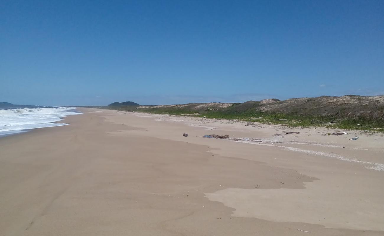 Фото Grande Beach с светлый песок поверхностью