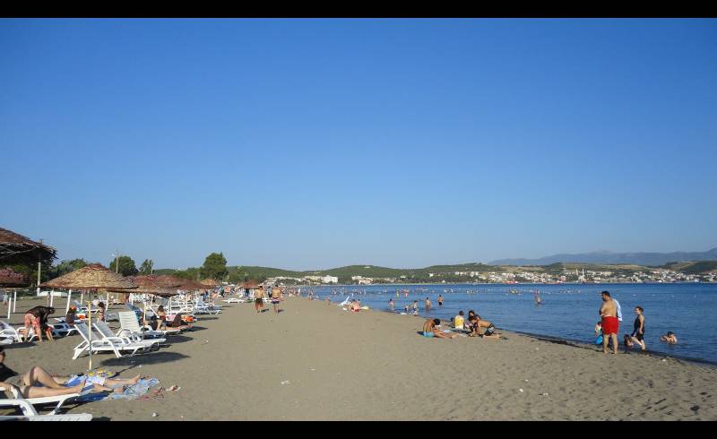 Фото Aliaga beach с светлый песок поверхностью