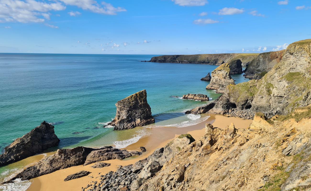 Фото Pentire Steps beach с золотистый песок поверхностью