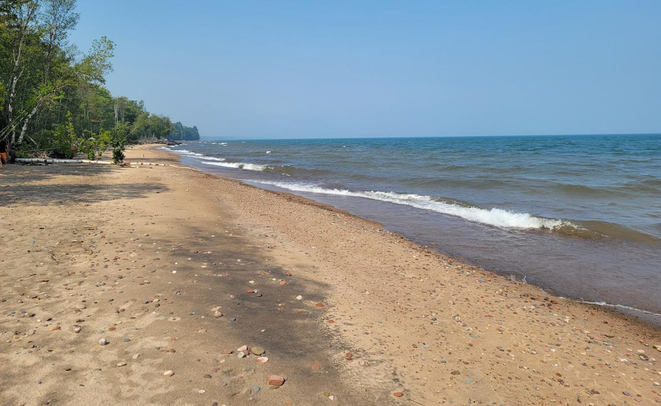 Фото Green Beach с светлый песок поверхностью